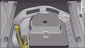 Luggage compartment with towing bracket